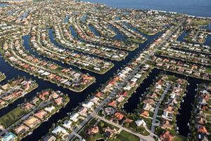 An aerial view features a coastal community. 