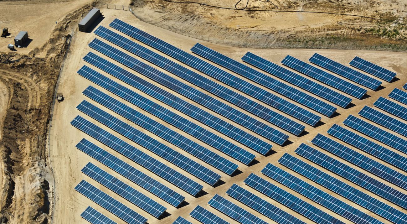 An aerial view of solar arrays on a brownfield.