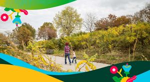 Child and caretaker taking a stroll in Louisville Waterfront Park.