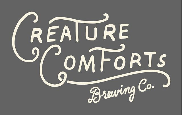 white creature comforts brewing co logo over gray background