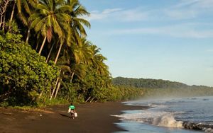 Ranger Anita Rosta Posala walks along Haevo beach at sunrise.