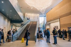 Looking up a staircase in a busy lobby. 
