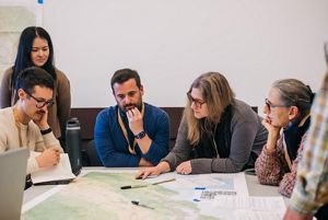 People at a table reviewing a map. 