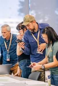 Symposium attendees looking over a table. 