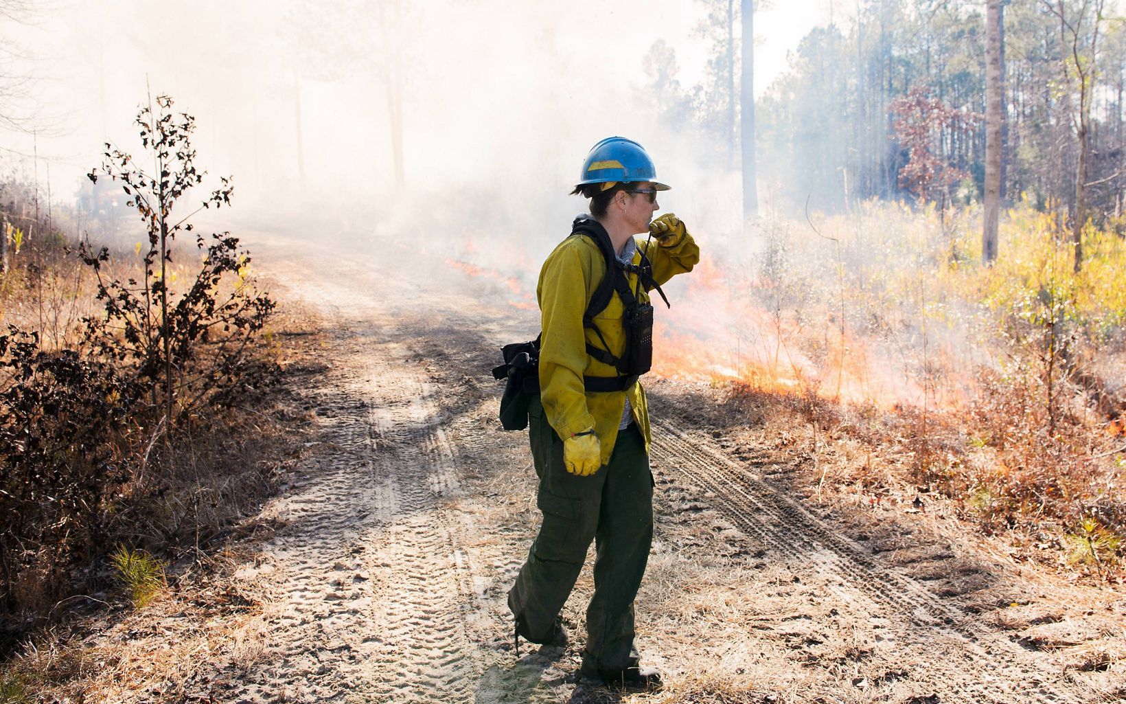 Crew members constantly communicate with each other during a controlled burn via radio.