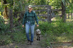Maria Gorete walking with a goat.
