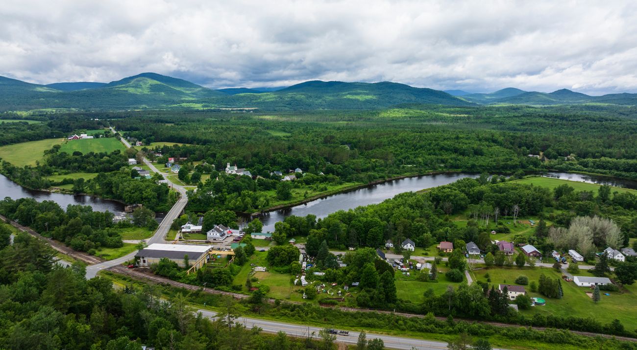 Aerial image of a towns, a river and mountains.