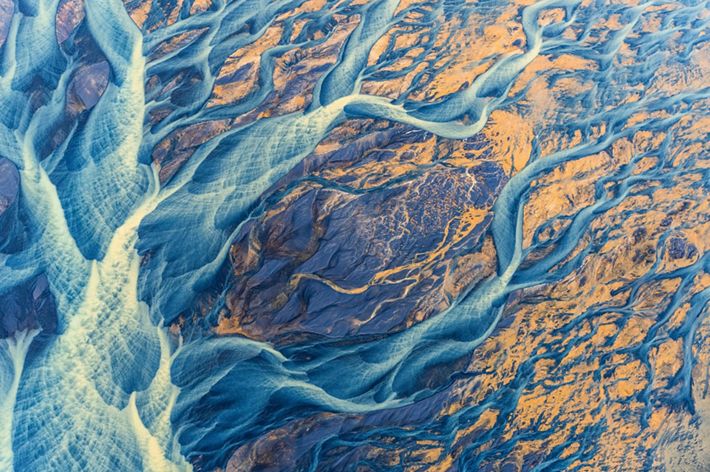 Brightly colored sediment paints the Icelandic landscape as at flows towards the ocean. The glacial river, Þjórsá, is the longest river in Iceland.