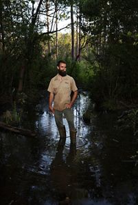 Eric Soderholm standing over a wetland.