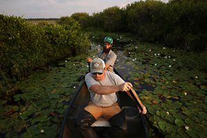 Two men paddling a canoe 