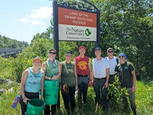Interns standing in front of a preserve sign.