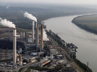 Pollution emerges from a power plant located next to a creek.