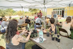 People sitting at tables outside. 