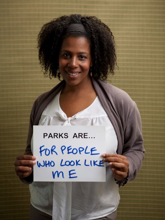 Rue Mapp portrait. She holds a sign saying 'Parks are for people who look like me'.