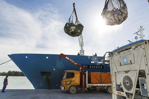 Huge nets full of tuna are hoisted off a fishing trawler.