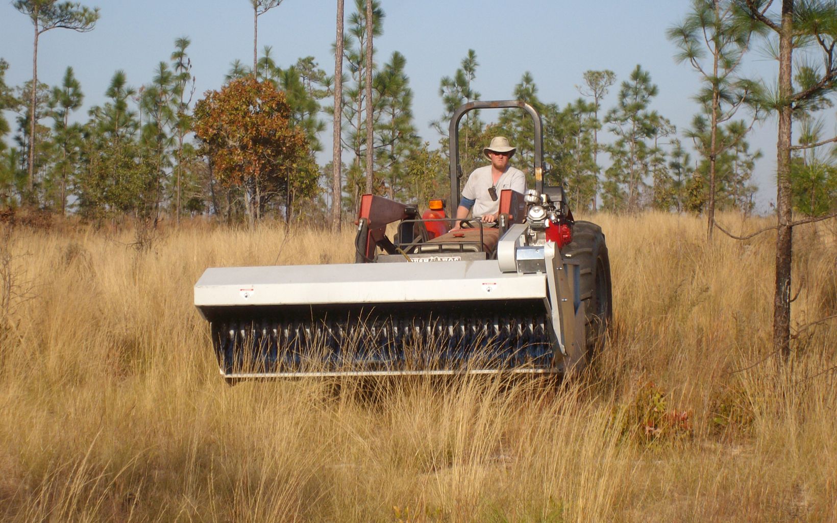 A tractor is used to collect native groundcover seed mix for future planting at Apalachicola Bluffs and Ravines Preserve.
