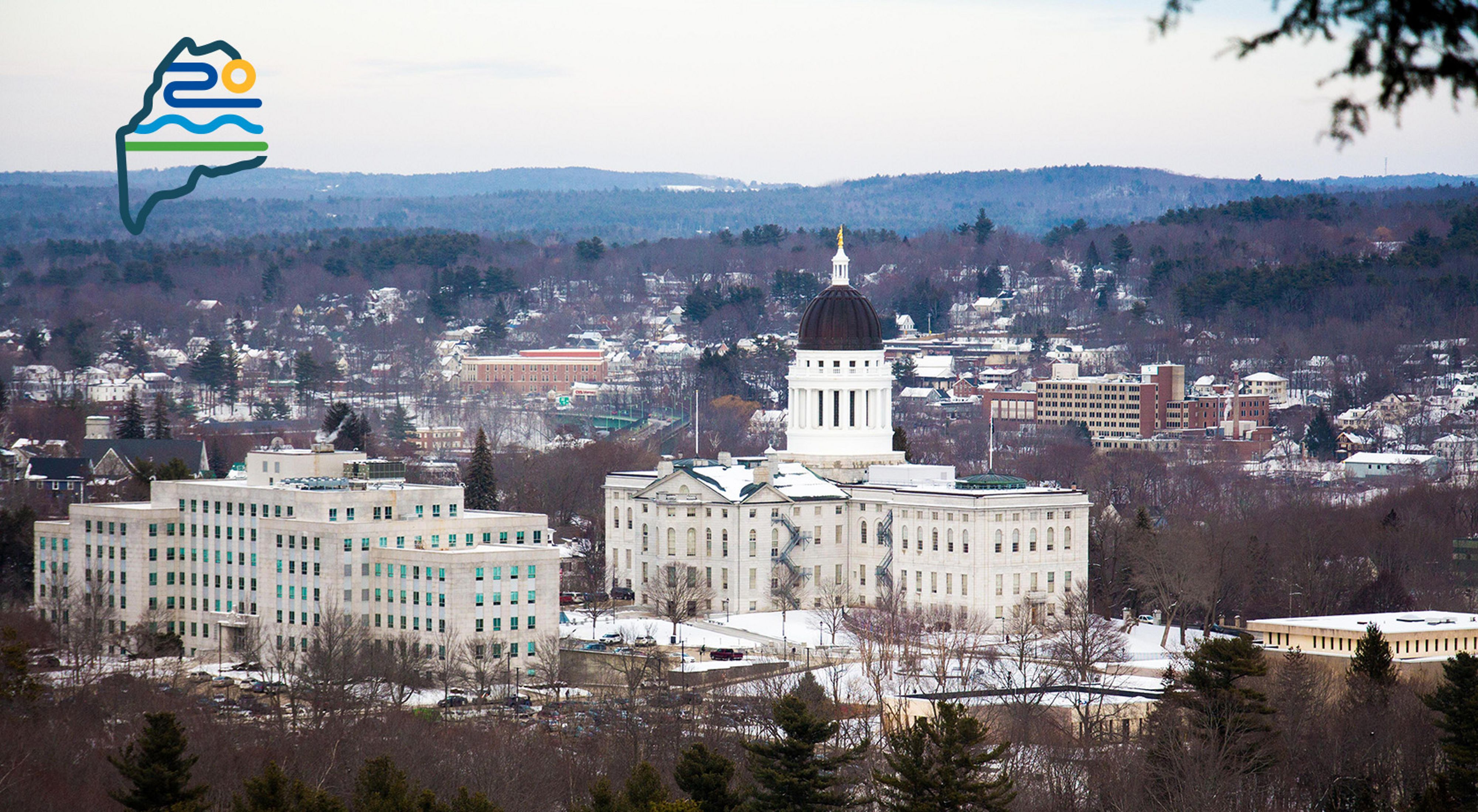 A view of the Maine statehouse from a surrounding hill.