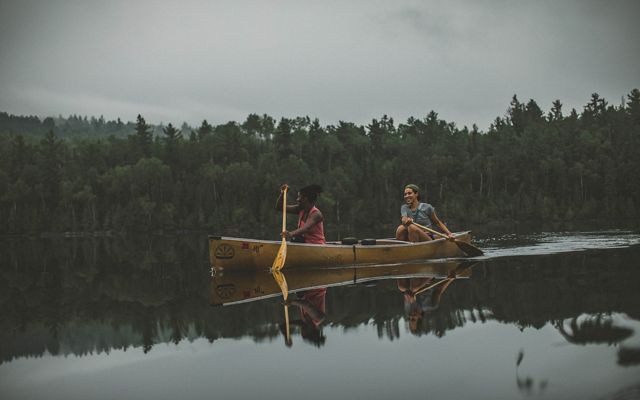 Two people paddling a canoe within the boundary waters of the Superior National Forest that provides a climate resilient landscape for wildlife and outdoor recreation.