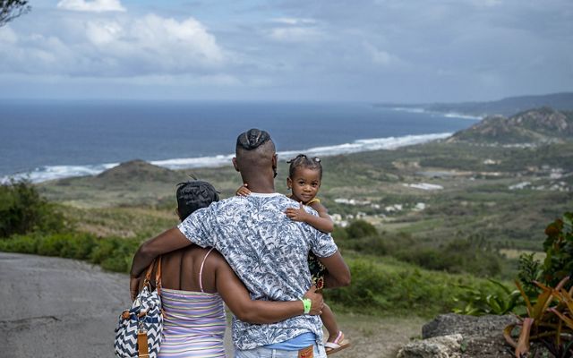 Family overlooking hill in Barbados