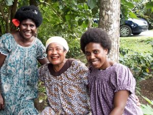During a workshop in Palau, women visited a local taro patch to learn conservation practices. Left to right: Attendee Barbara Masike, taro patch owner, attendee Marietta Pau.