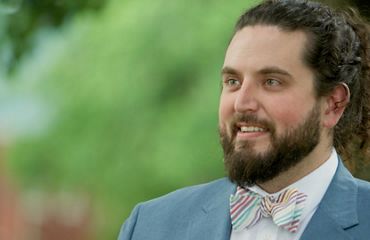 Photo of Boone Bowling wearing a blue blazer and colorful bowtie.