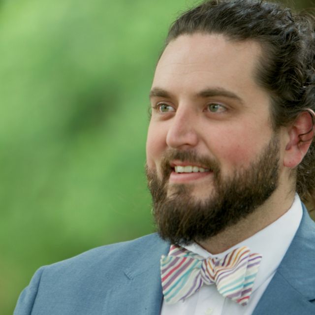 A photo of Boone Bowling, a smiling man with a beard and a bowtie.