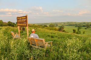 Sign and bench on a hill overlooking Broken Kettle Grasslands Preserve.