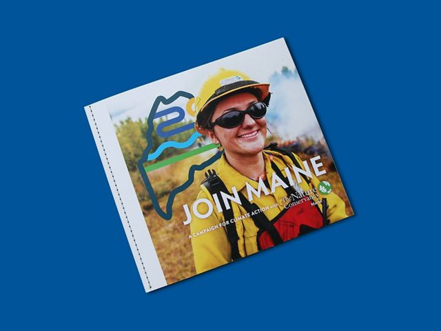 A booklet with a prescribed fire fighter on the cover sits in a blue background.
