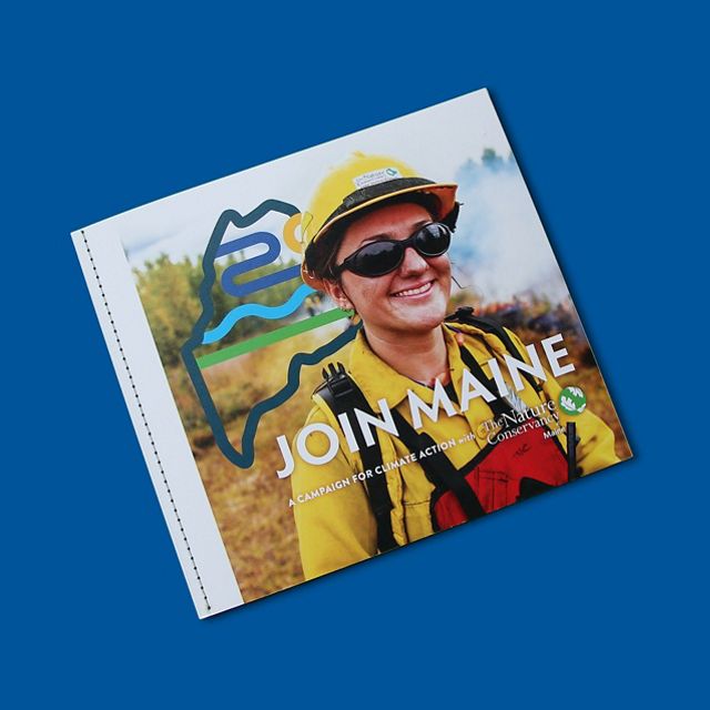 A booklet with a prescribed fire fighter on the cover sits in a blue bachground.