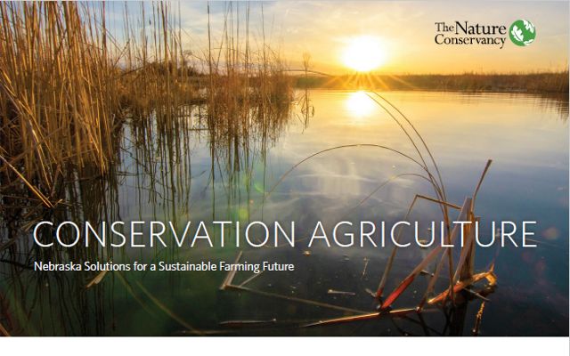 The cover of the Conservation Agriculture report featuring a view of a wetland at sunset.