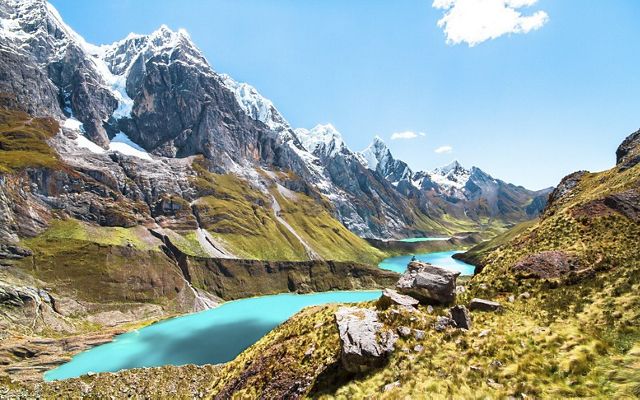 Brilliantly colored glacial lagoons sit beneath peaks and glaciers of monstrous sizes in the Cordillera Huayhuash, Peru.