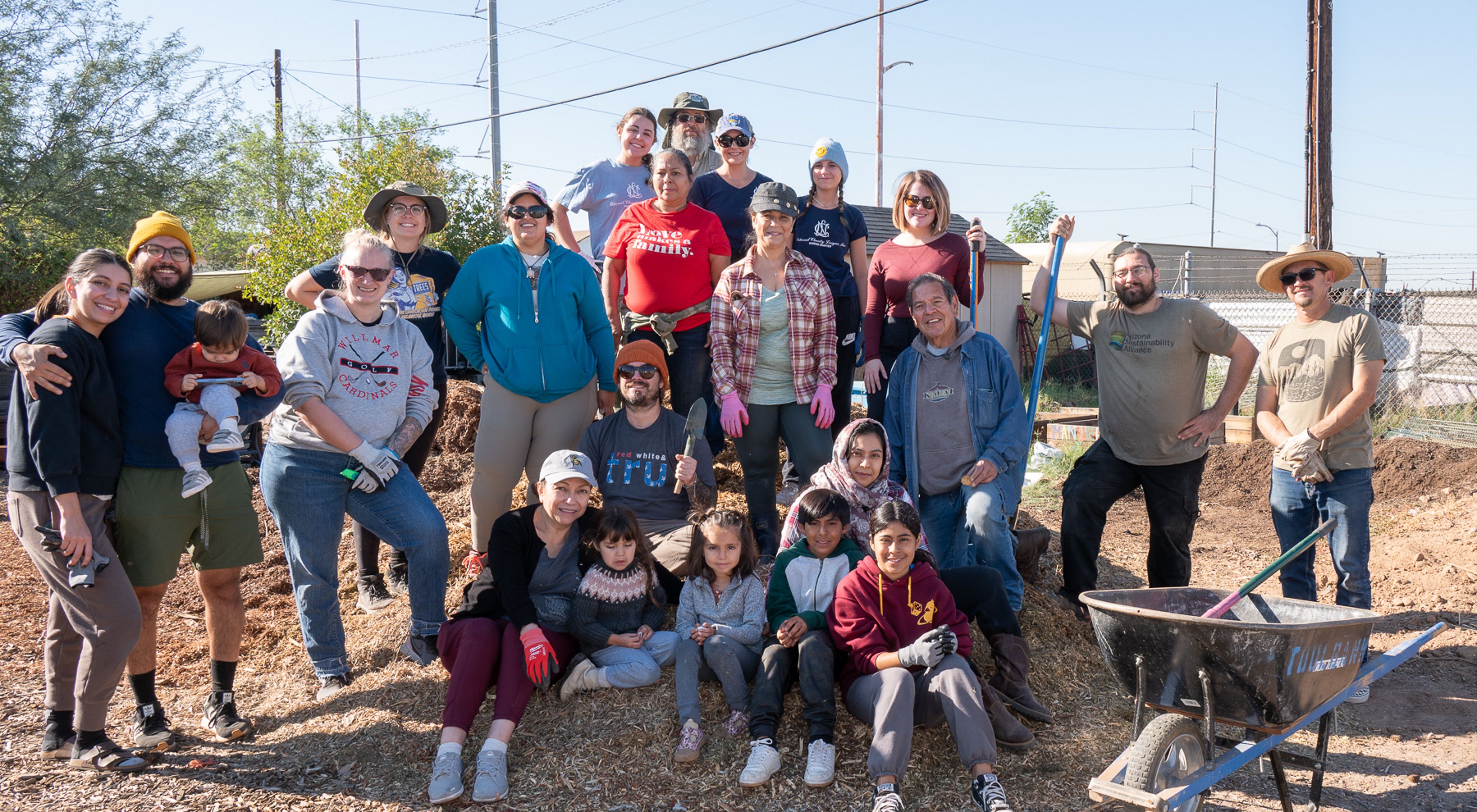 A group of volunteers pose after completing a tree planting event in Phoenix, AZ.