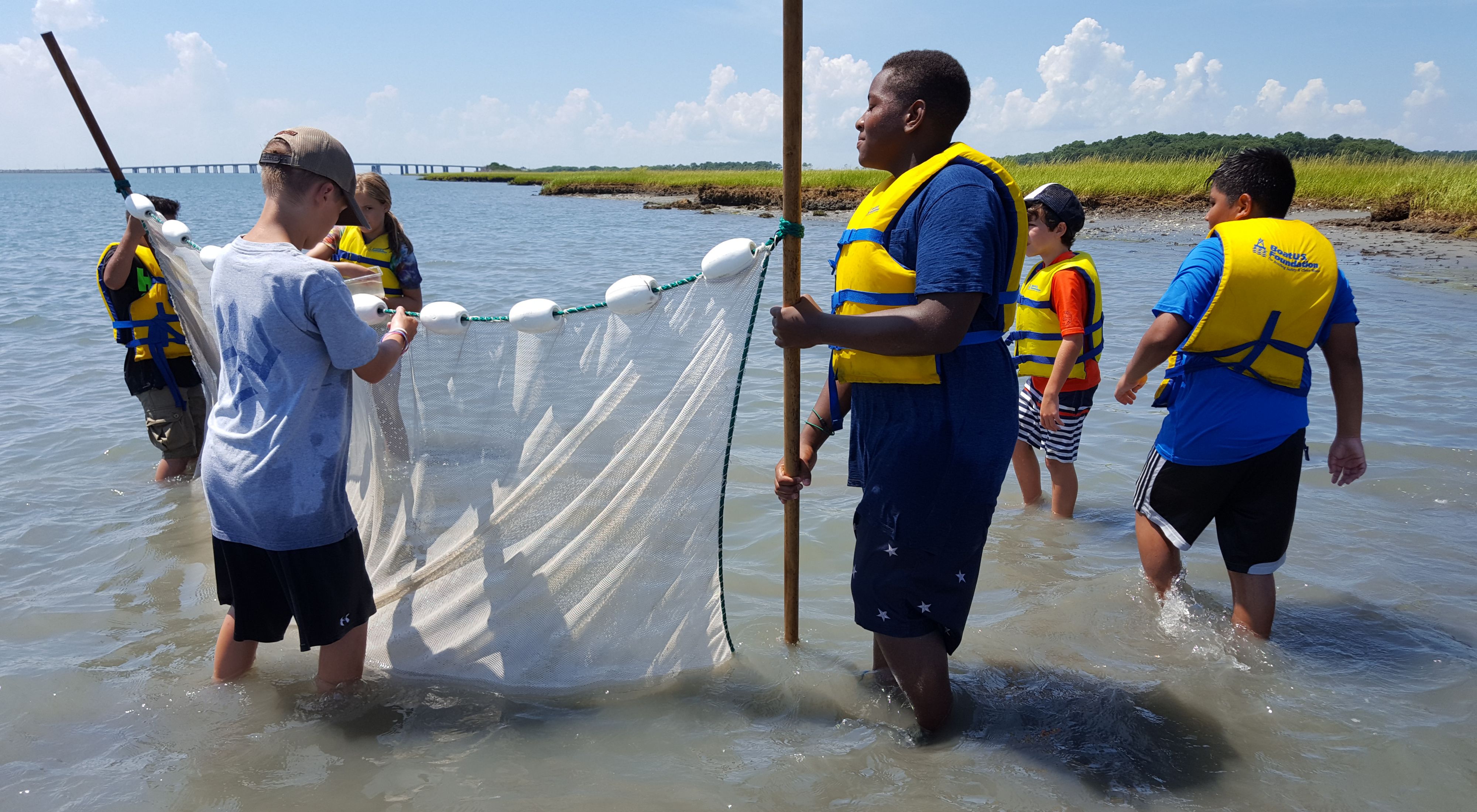 TNC's VVCR Education Program participants wear life jackets while working together in the water on the Eastern Shore. 