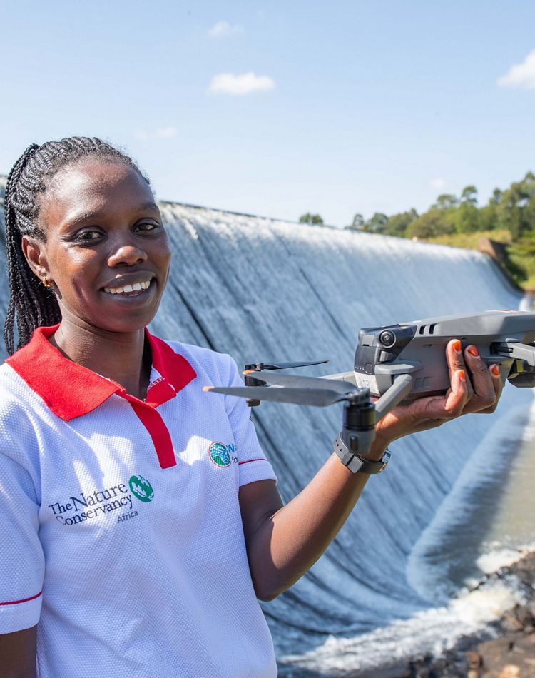 A TNC employee holding a drone.