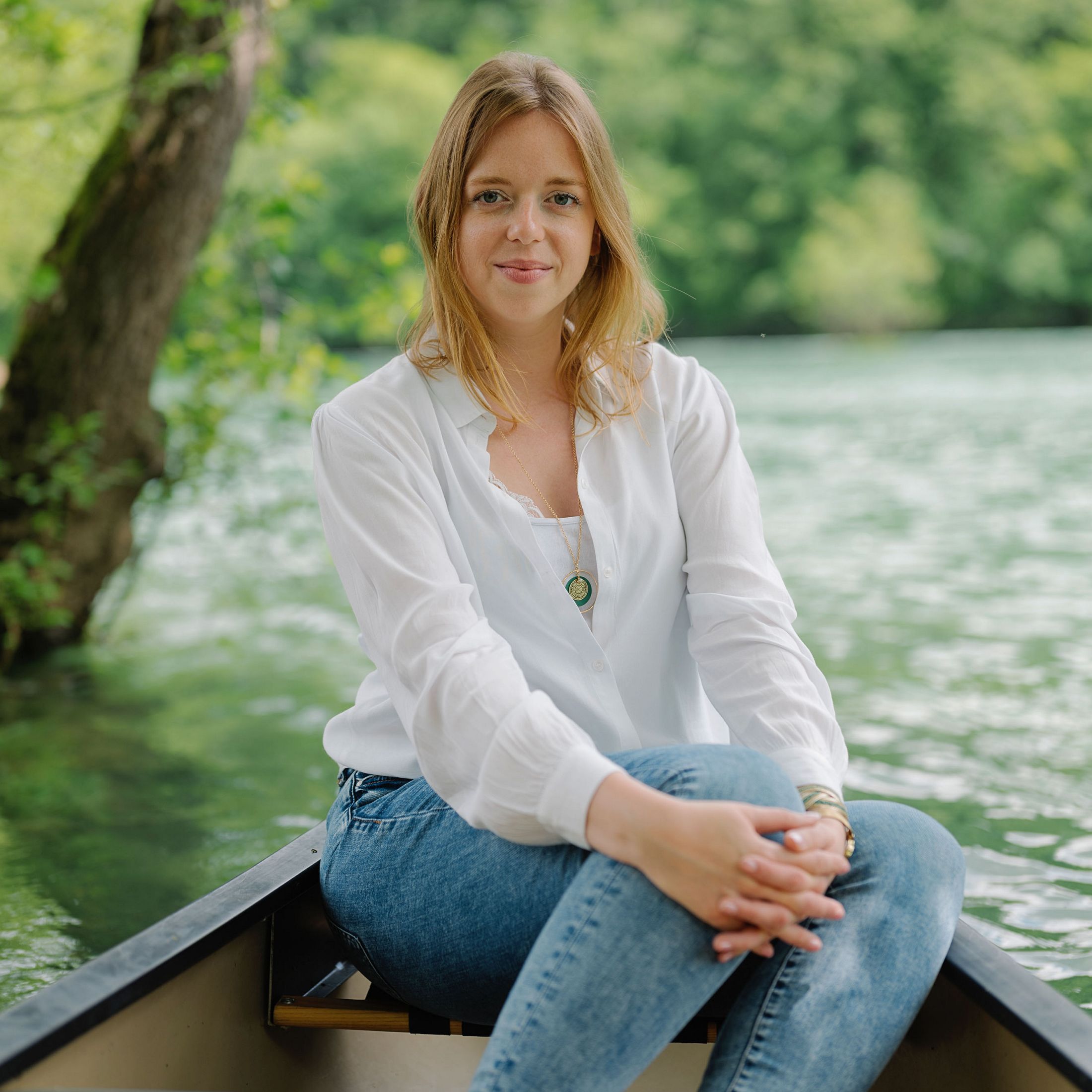 Dragana Mileusnić sits in a boat along the Mrzenica River in Croatia. She works to protect the rivers of SE Europe and promote the sustainable siting of renewable energy.