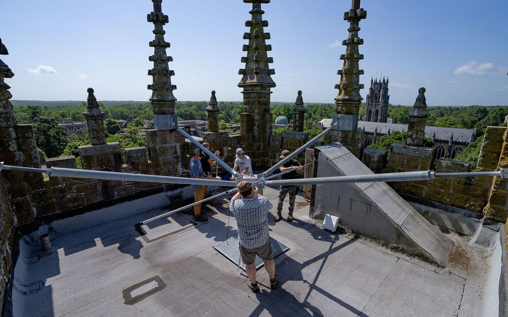 
                
                  Listening Cory Holliday directs the installation of a Motus wildlife tracking receiver on the top of Breslin Tower at Sewanee: The University of the South.
                  © Stephen Alvarez
                
              