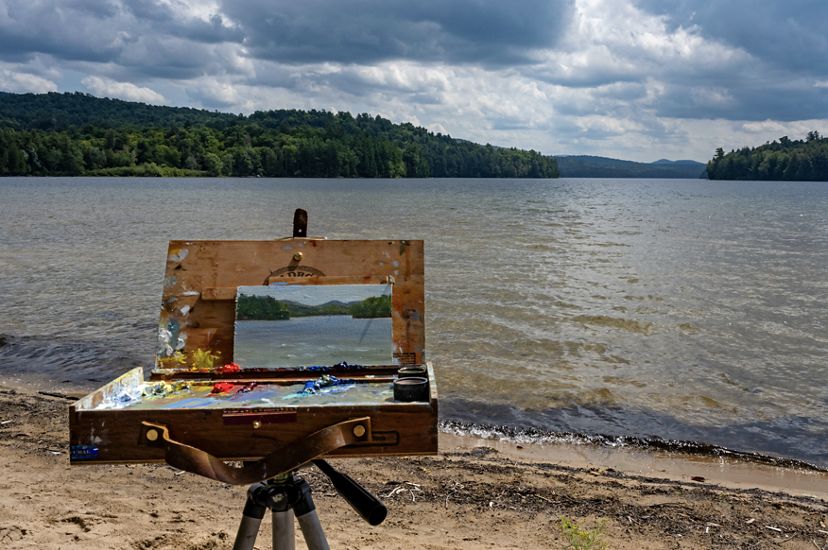 A canvas with a painting of the river in front of the river. 
