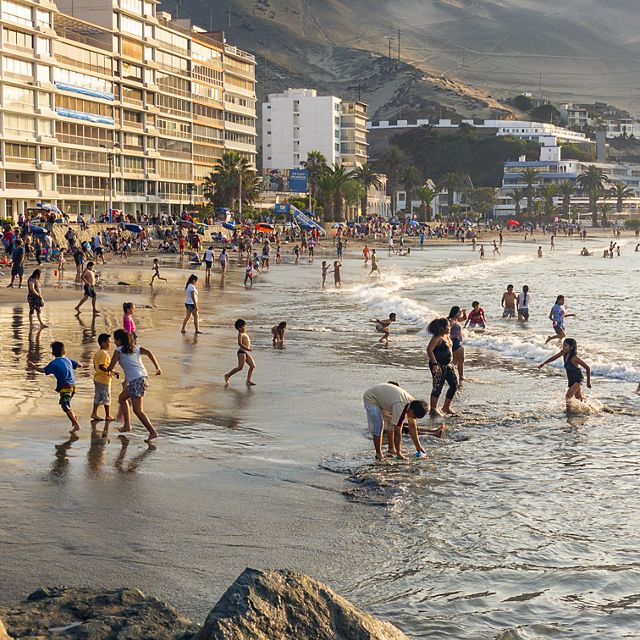 People enjoy playing on a beach in Ancon, Peru.