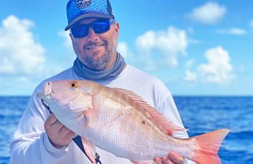 Florida fisheries manager David Moss holds a large freshly-caught mutton snapper.