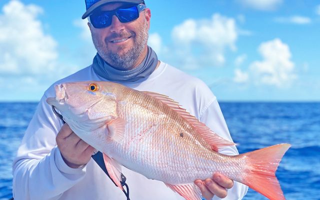 Fisherman holds a freshly caught mutton snapper in the Florida Keys. 