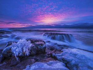 Blue and purple sky over a frozen North Shore of Lake Superior.