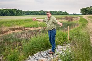 Farmer Les Seiler shows vegetated buffer on his farm.