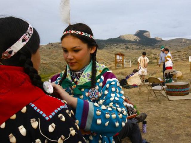 Two participants in a ceremony on top of a mountain.