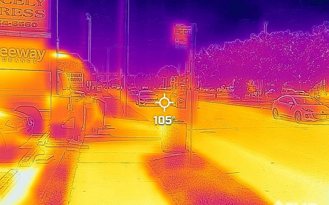 A heat map of a street with cars and nearby buildings and trees.