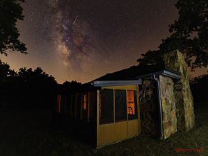 The cabin of John Joseph Mathews frames the Pawhuska night sky. 