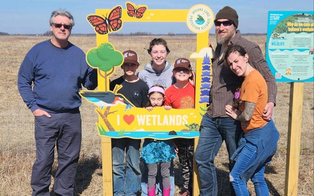 Visitors to Kankakee Sands use the I Love Wetlands photo frame.