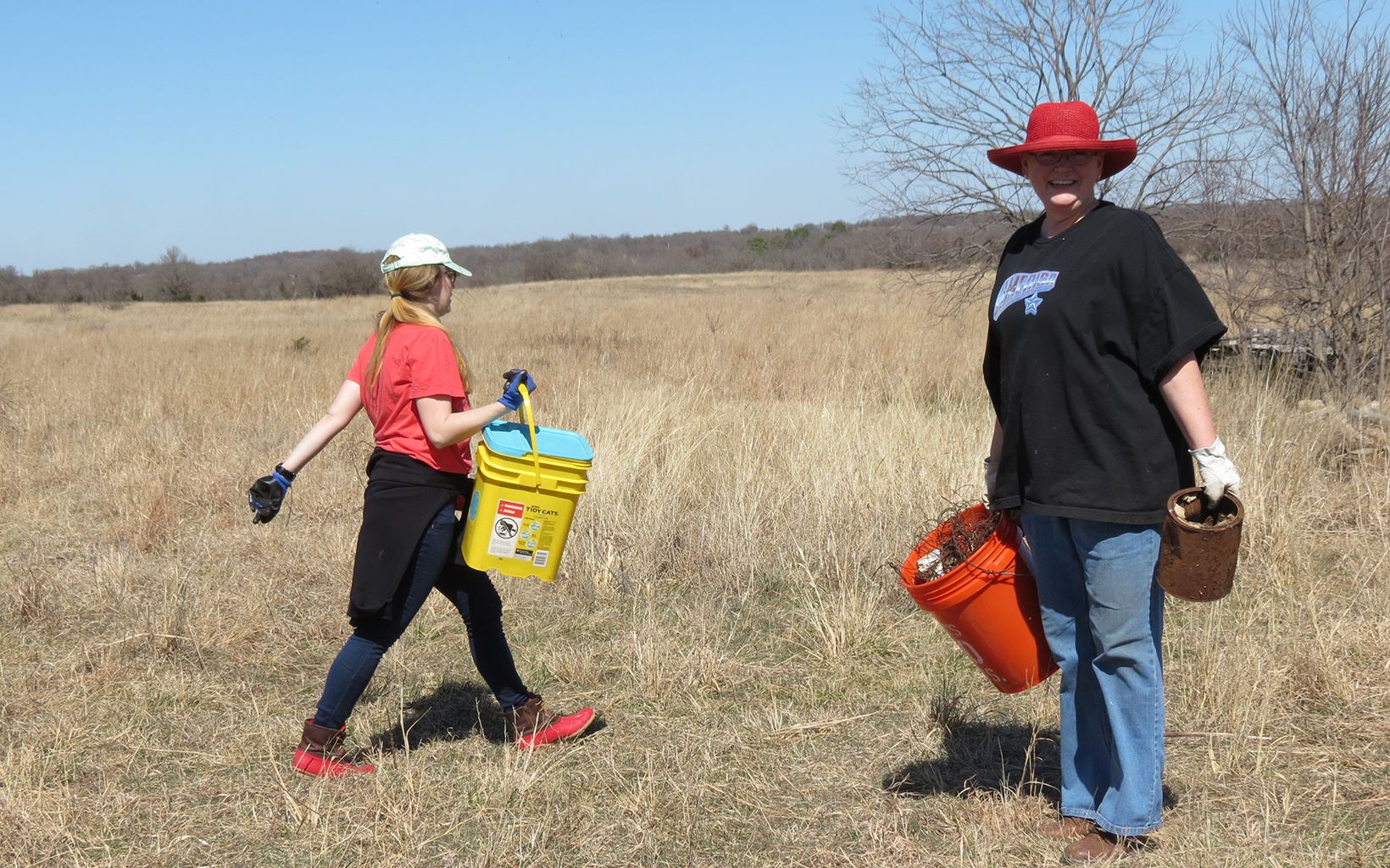Volunteer picking up trash along Blue River