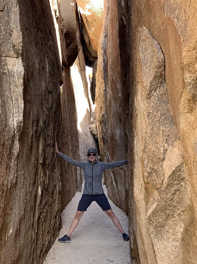 kathleen standing in a slot canyon.