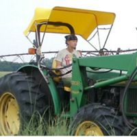 Nature Conservancy staff riding a tractor.