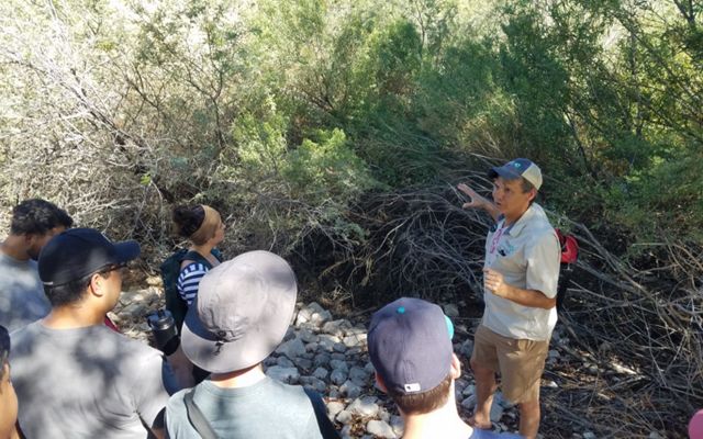 Leonard Warren explaining native species habitat to UNLV landscape architecture students and informing their designs during a field trip to Clark County Wetlands Park.